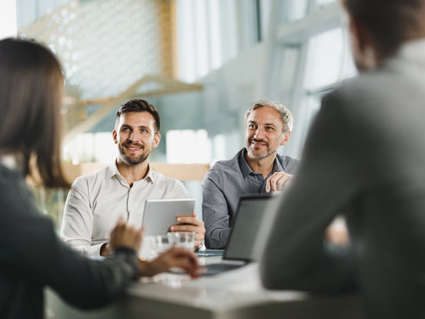 Two business man talking and smiling